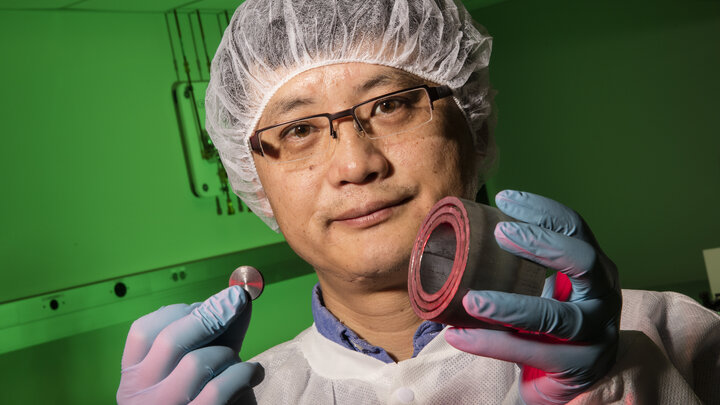 Shouyuan Chen, UNL research assistant professor of physics and astronomy, shows a uranium disk and steel casing. An X-ray laser successfully imaged the uranium hidden within the casing.