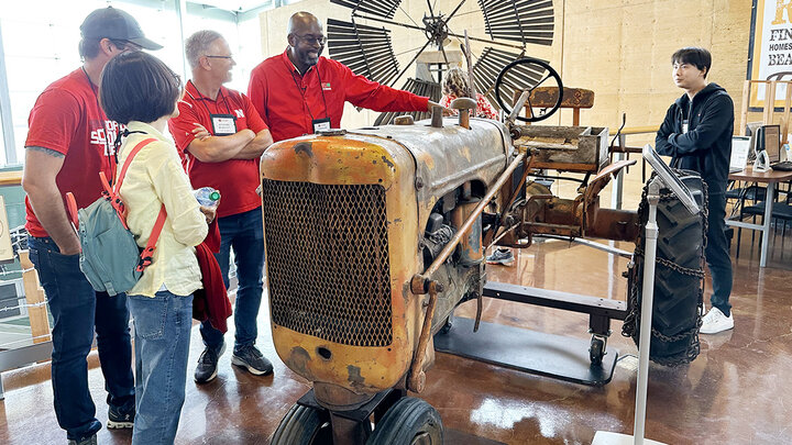 Chancellor Rodney Benefit looks at a tractor used by the last homesteader at Homestead National Historic Park in Beatrice, Nebraska.