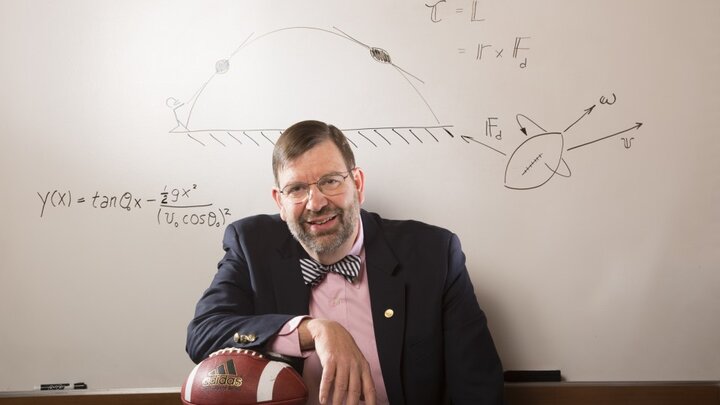 Tim Gay next to whiteboard